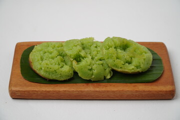Cara bika or carabikang cake, traditional Indonesian cake on a wooden plate isolated on a white background
