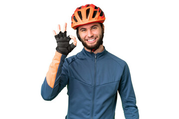 Young cyclist man over isolated chroma key background showing ok sign with fingers