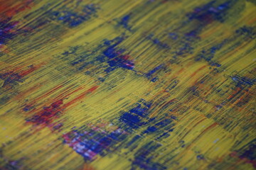 Obraz premium Mixed yellow acrylic paint splatter on top of a blue paint surface, Multicolor paint splash textured backdrop, Vintage mixed color pattern strokes background