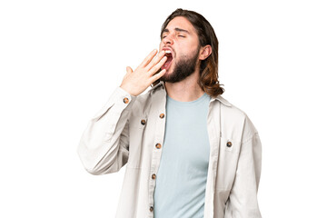 Young handsome man over isolated chroma key background yawning and covering wide open mouth with hand