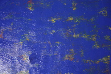 Mixed rough paint splatter on a textured blue paint surface, Grungy colorful paint brush strokes backdrop, Abstract multicolor paint splash background