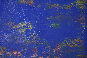 Mixed rough paint splatter on a textured blue paint surface, Grungy colorful paint brush strokes backdrop, Abstract multicolor paint splash background