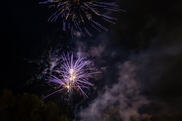 Fireworks with pattern of lights in the night sky as background.