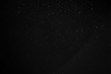 abstract real dust floating over black background for overlay