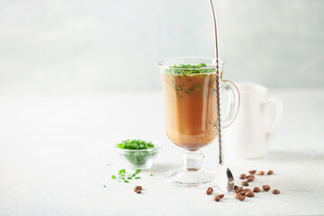 Chinese scallion coffee latte. Cold iced coffee with fresh spring onions in glass. Copy space