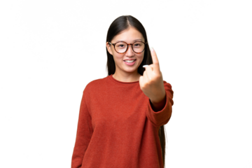 Young Asian woman over isolated background with fighting gesture
