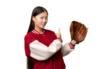 Young asian woman with baseball glove over isolated background pointing back