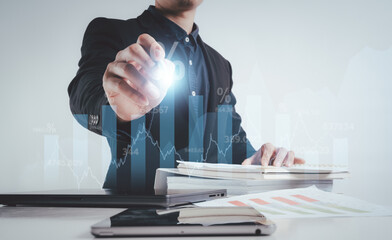 businessman on document planning the business plans and analyse  profitability of working companies with digital augmented virtual graphics for project manager working on laptop and update information