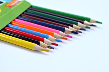 Fototapeta premium box with colored pencils on a white background close-up