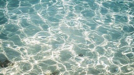 Obraz premium A close-up of cool, crystal-clear water with gentle ripples and light reflections.