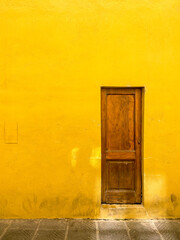 Wooden door in a yellow wall