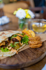 Indulge in a delightful Wrap Sandwich paired with crispy Potatoes and a refreshing Drink