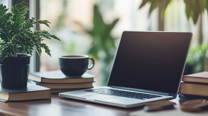 Laptop on a Table with a Cup of Coffee and Books