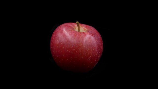 Red apple rotating 360 degree with black background, asymmetric