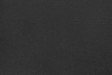 Texture of paper with dark gray ink as background, top view
