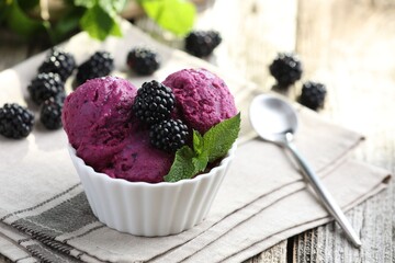 Delicious blackberry sorbet, mint and fresh berries on wooden table, closeup. Space for text