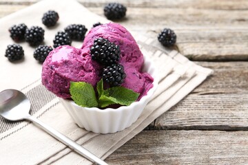 Delicious blackberry sorbet, mint and fresh berries on wooden table, closeup. Space for text
