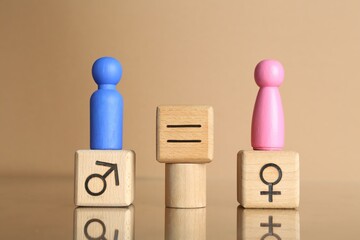 Gender equality concept. Male and female figures on beige background