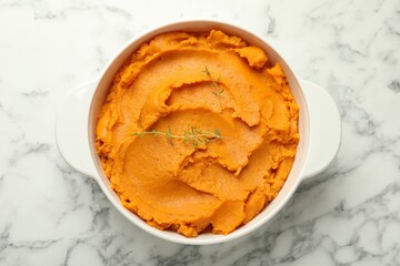 Delicious mashed sweet potatoes in pot on white marble table, top view