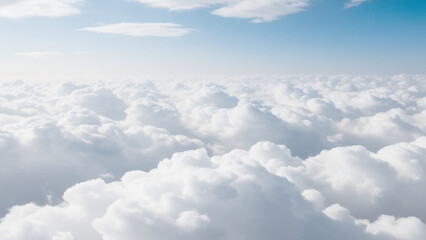 White Clouds from above. Aerial view of the fluffy white cloud on blue sky. Top view from an airplane over white clouds in a blue sky. High in the Heavens.