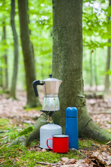 Picnic in the forest. Making coffee on a stump in the middle of a clearing.