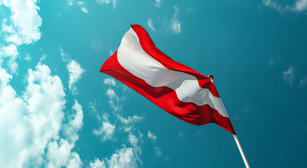 The flag of Austria flutters in the wind on a flagpole against a sky with clouds on a sunny day.
