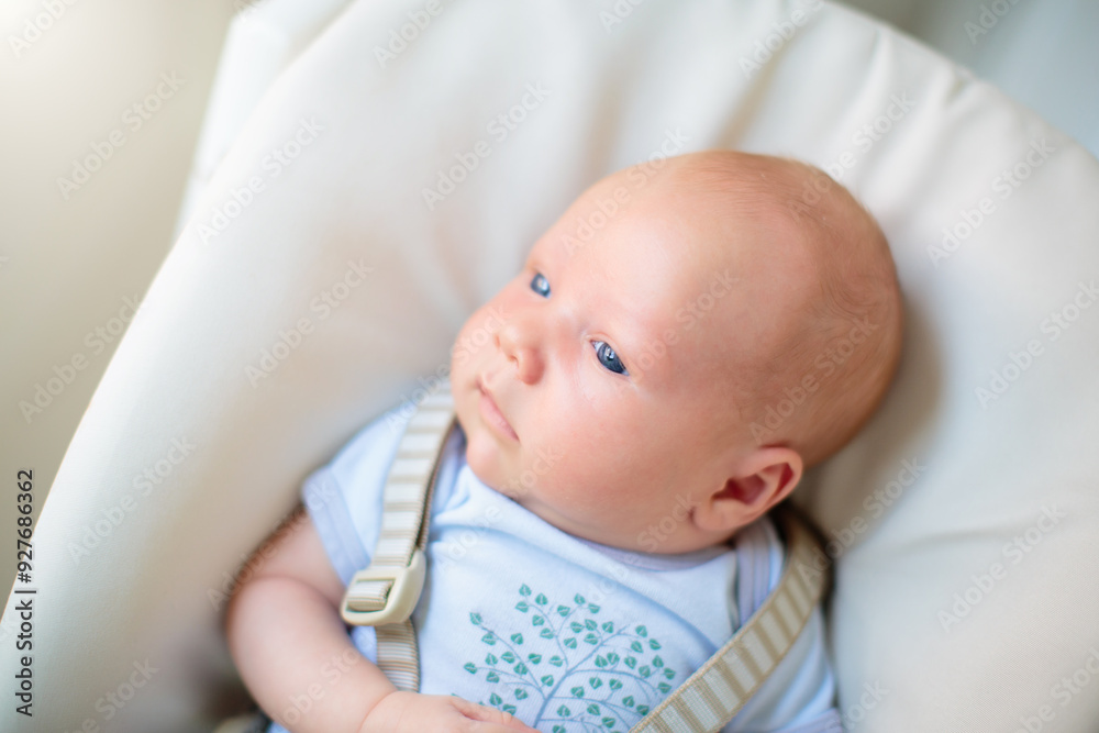 Wall mural Newborn baby boy in high chair