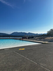 Kitsilano Pool in Vancouver offers a stunning view of the city skyline and surrounding mountains, making it a perfect spot for swimming and relaxation on a sunny day
