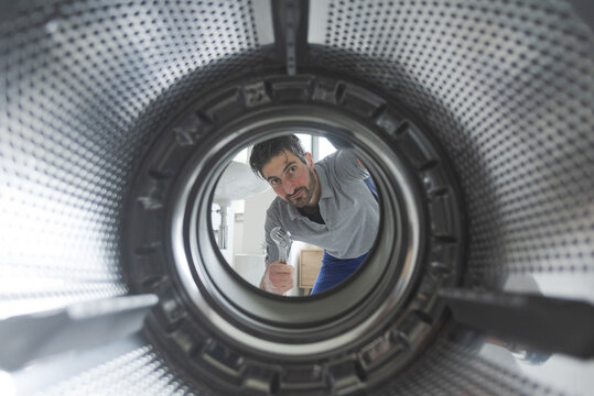 Repairman fixing a washing machine