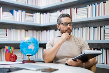Teachers day. Teacher in school classroom. Knowledge and education with middle aged teacher. Millennial teacher with book. Teachers from university exam. College teacher.