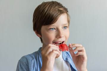 Child boy wears an orthodontic device on the upper jaw. Concept of healthy and even teeth and a beautiful smile © irena_geo