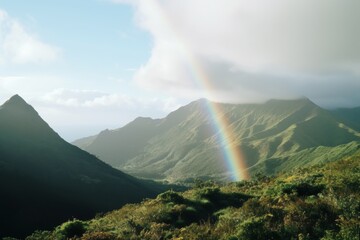 Majestic green mountains with a rainbow in the sky.