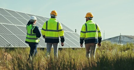 Team at solar panel farm for inspection, clean energy and outdoor electricity maintenance from back. Sustainability, photovoltaic power grid system and technician with engineer to check development. - Powered by Adobe