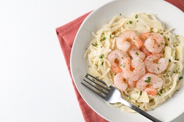 Delicious pasta with shrimps and cheese on white table, top view. Space for text