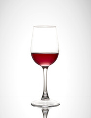 glass of red wine on white gradient background