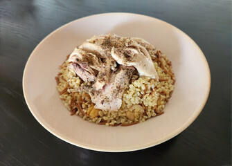 Turkish bulgur pilaf  topped with boiled chicken pieces