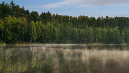 Morning over a forest lake with fog, in the Czlopa commune near Mielecin