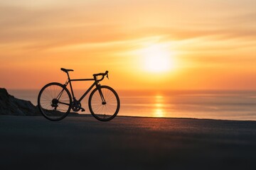Obraz premium Serene Sunset Cycling: Solo Road Bike Against a Calming Ocean Horizon