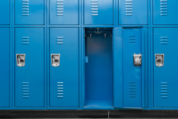 Single open empty blue metal locker along a nondescript hallway in a typical US High School. No...