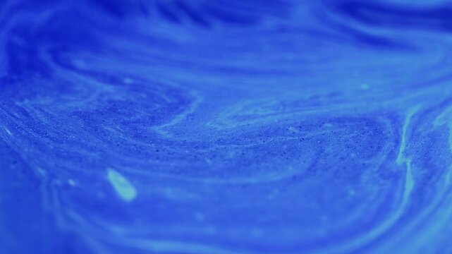 Ink motion. Glitter emulsion. Defocused blue liquid strip waves flow azure silver mix abstract glowing art texture sparkling background.