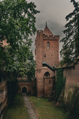 Malbork Castle Tower and Brick Walls on a Cloudy Day © Aliaksandr