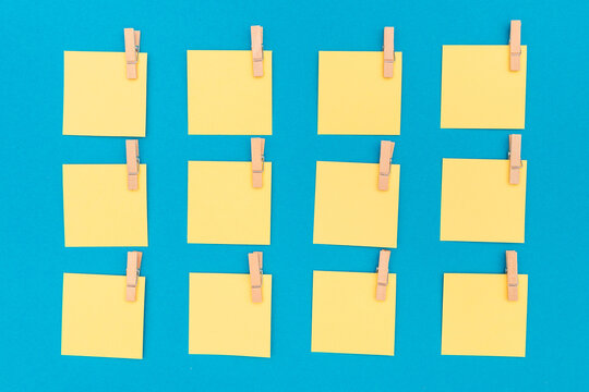 Yellow notes pinned with clothespins on a blue background
