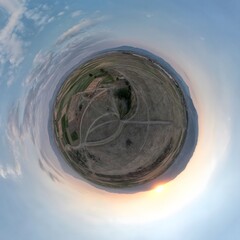 Little planet transformation of spherical panorama 360 degrees. Spherical abstract aerial view with beautiful clouds. Curvature of space.