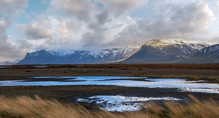 View during auto trip in West Iceland highlands, Snaefellsnes peninsula, Snaefellsjokull National Park. Spectacular volcanic tundra landscape with mountains, craters, lakes, gravel roads.