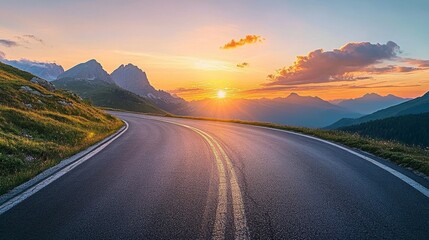 In spring, a scenery with the empty highway through the mountain pass, a colorful sunset, and rocks and stones are mixed with blue skies and clouds. This is a landscape with a curved road, rocks and