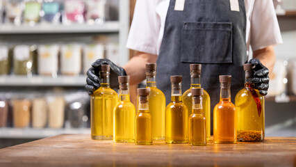 Master of production hold bottles with craft oil on workplace background