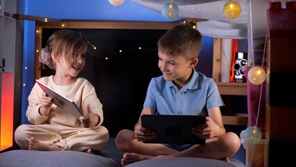 children using digital tablet computers, playing games, watching cartoons  - Powered by Adobe