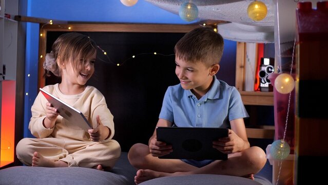 children using digital tablet computers, playing games, watching cartoons 