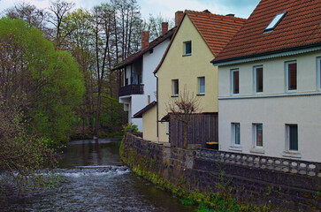 Scenic cityscape view of colorful ancient building in the river bank. Oldtown in Kronach. Typical architecture in Bavaria, region Upper Franconia, Germany. Travel and tourism concept