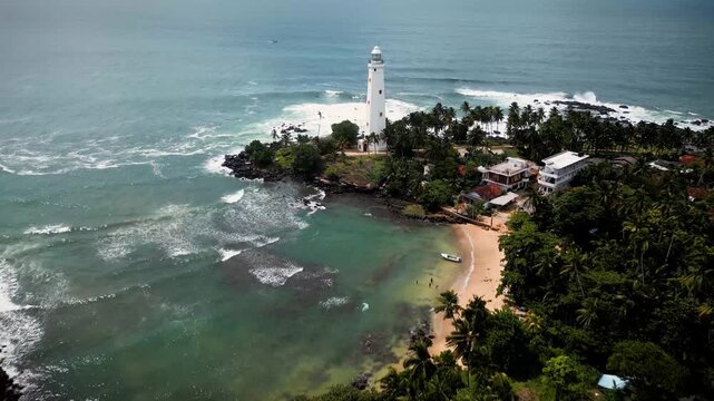 Aerial drone footage of a island lighthouse, showcasing its serene surroundings and the natural beauty of the ocean landscape